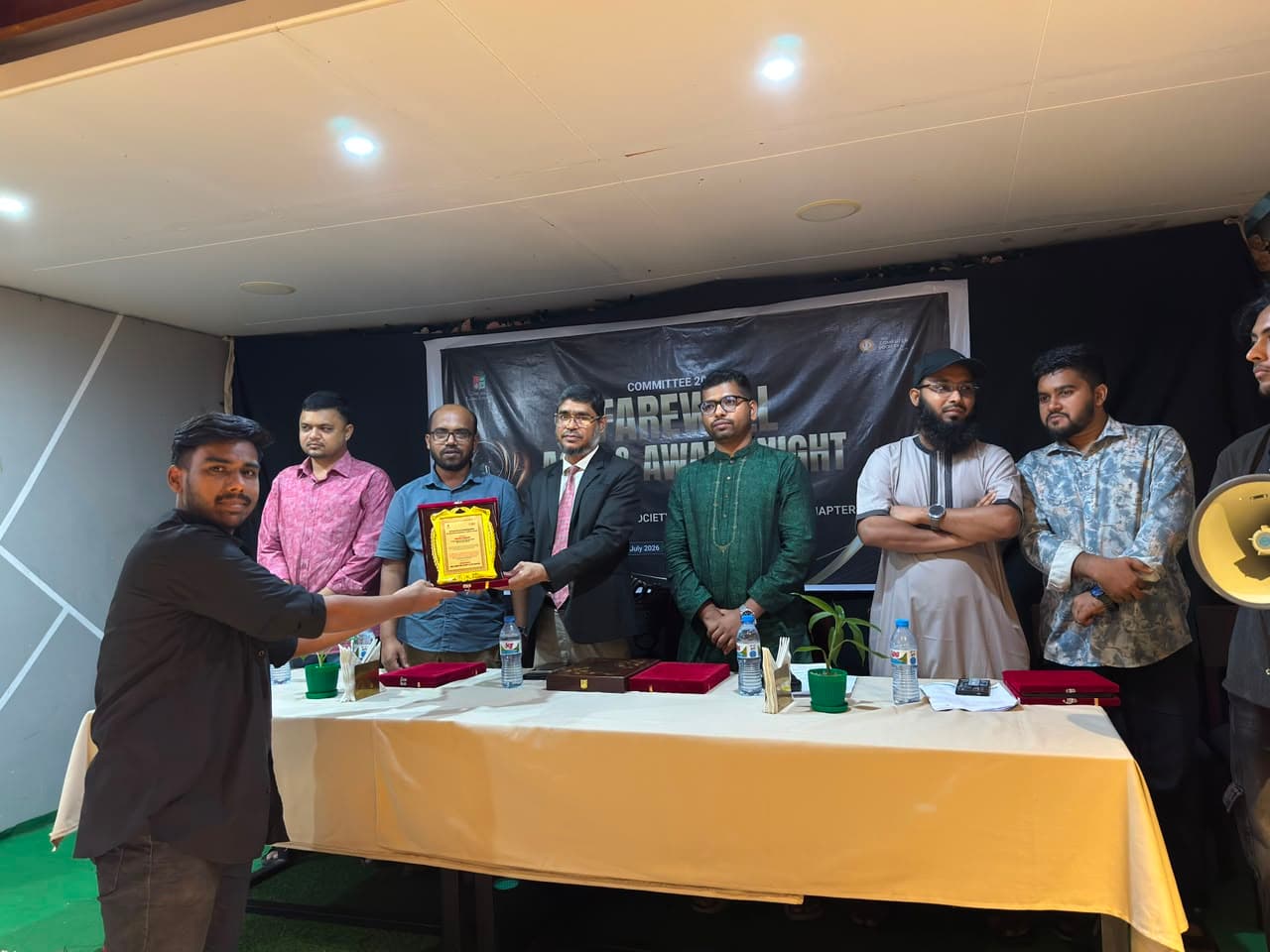 Badar Hossain, Co-Founder and Chief Operating Officer of Ravenence Limited — receiving a crest of recognition at a university chapter farewell and award night